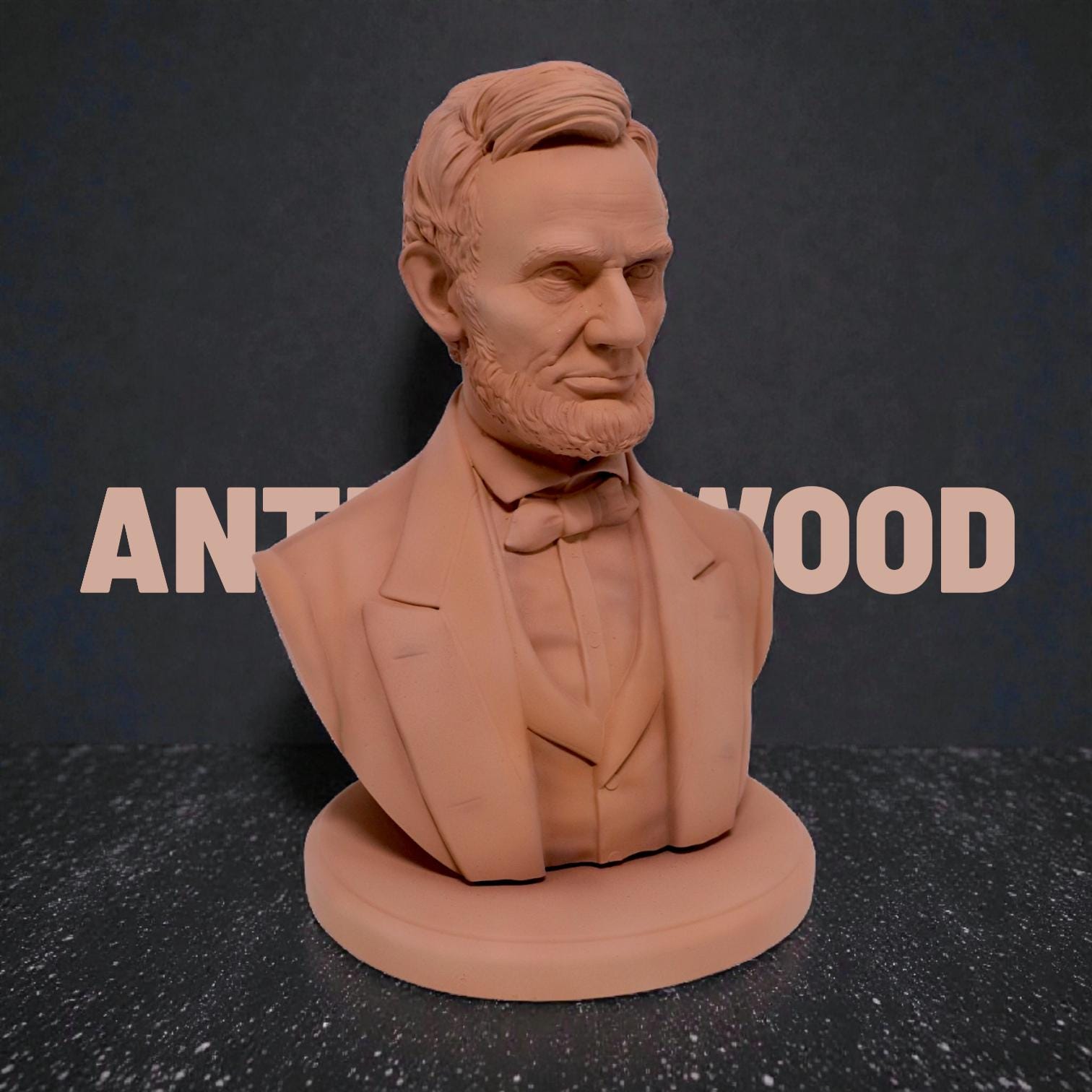 Silver-colored bust statuette of Abraham Lincoln, showcasing detailed facial features, a neatly trimmed beard, and formal attire with a bow tie, mounted on a rectangular base.