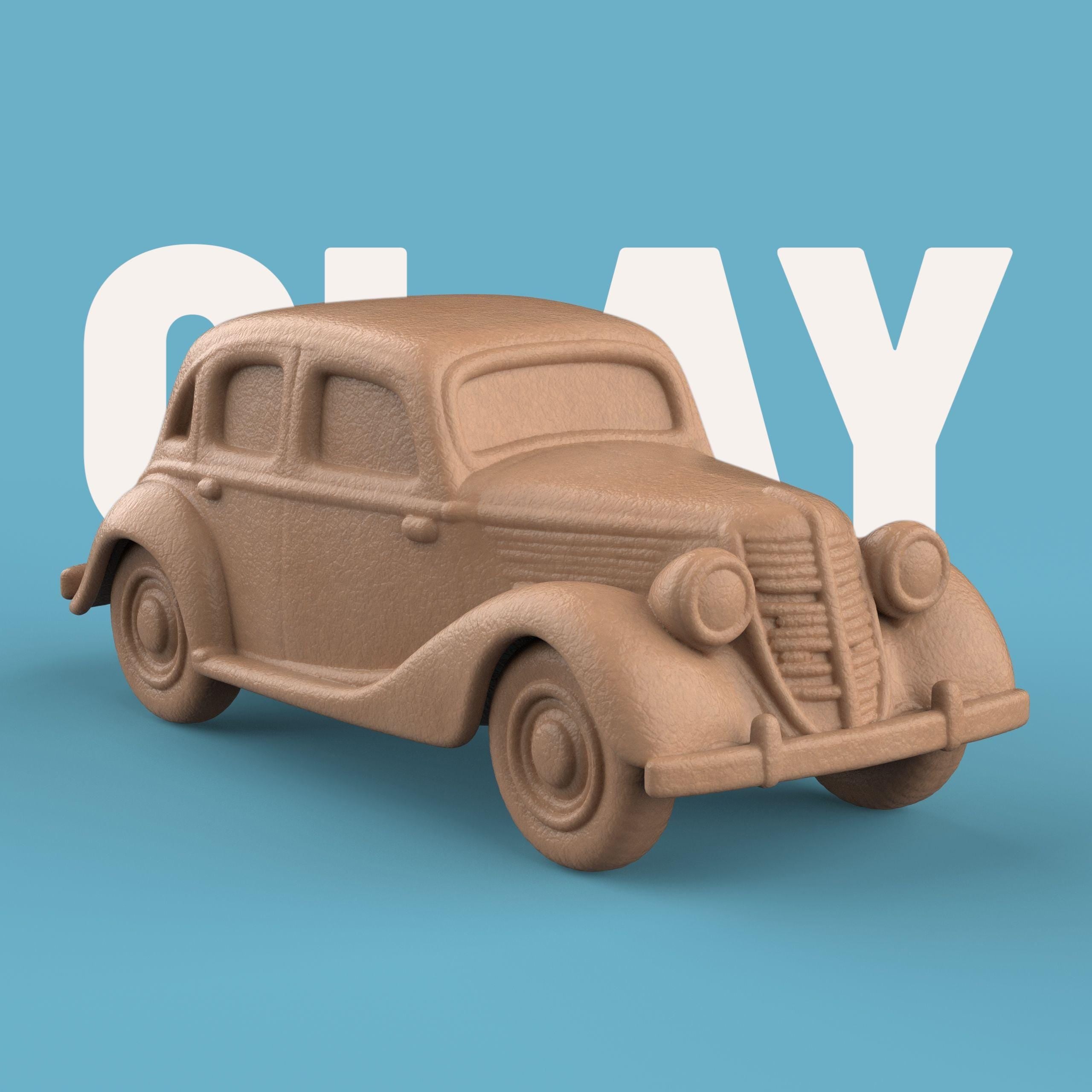 3D-printed model of a Renault 1940 BKF1 vintage car. The miniature captures smooth rounded fenders, detailed headlights, and a classic front grille design, representing the early 20th-century French automobile style.