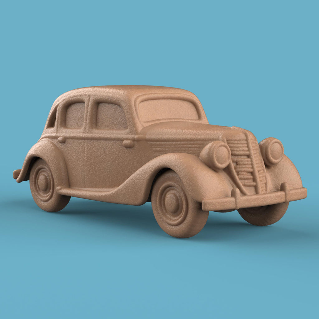 3D-printed model of a Renault 1940 BKF1 vintage car. The miniature captures smooth rounded fenders, detailed headlights, and a classic front grille design, representing the early 20th-century French automobile style.