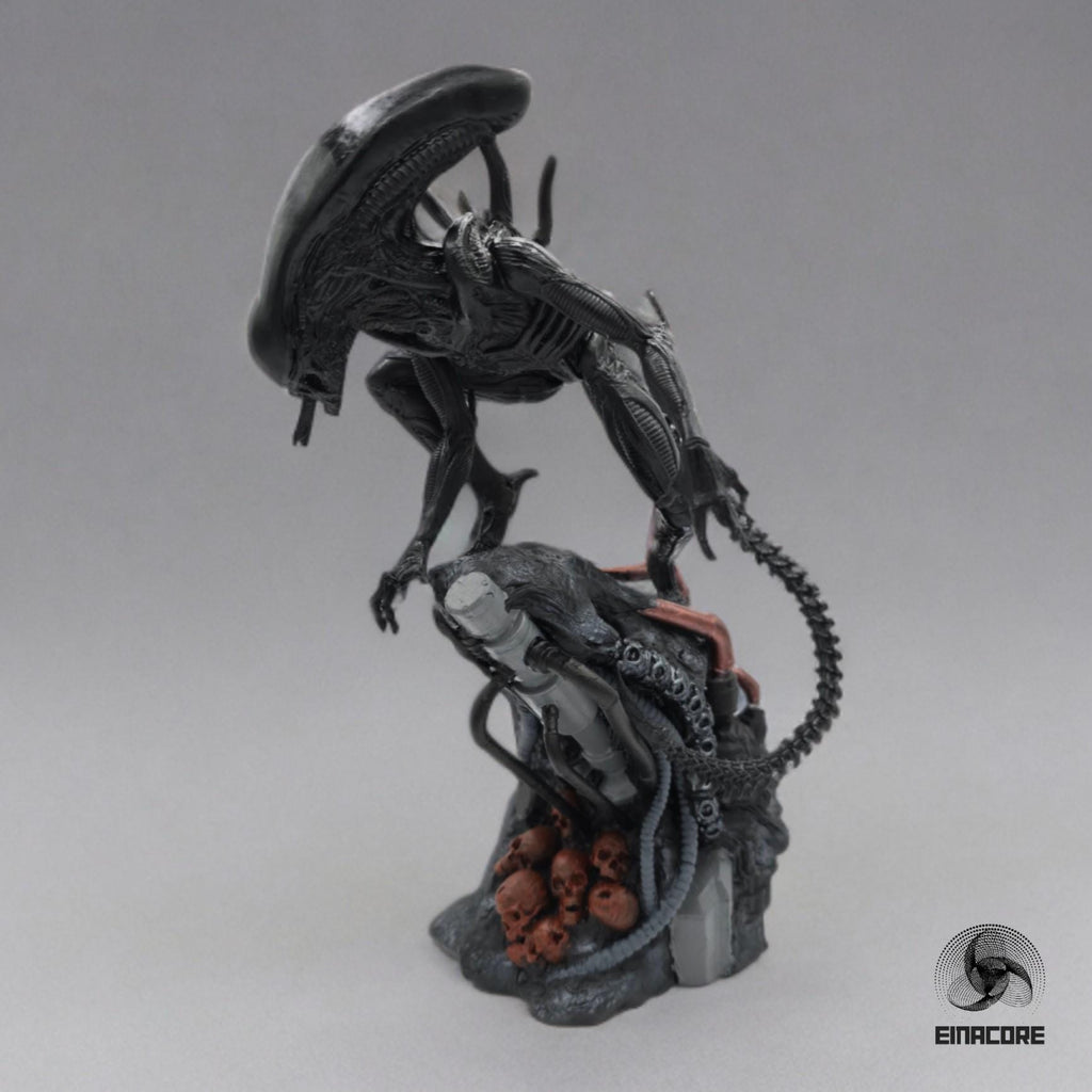 Alien Exomorph Statuette featuring intricate biomechanical details, posed on a rocky base with skulls and metallic pipes, showcasing the creature’s iconic tail and menacing posture.