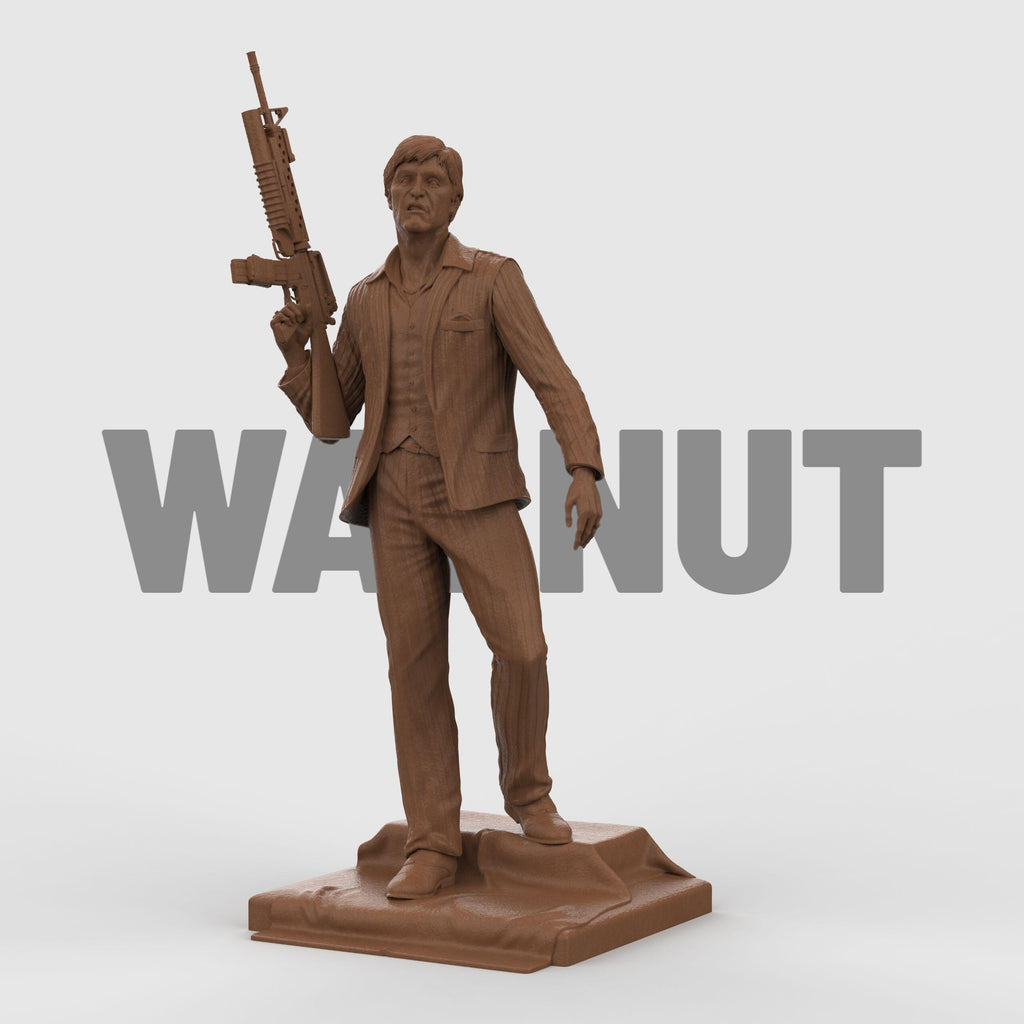 3D-printed statue inspired by Scarface, depicting a suited man in a confident pose, holding an assault rifle over his shoulder. The figure wears a detailed pinstripe suit and stands atop a textured base, capturing a bold and iconic cinematic moment with lifelike facial expression and dynamic stance.