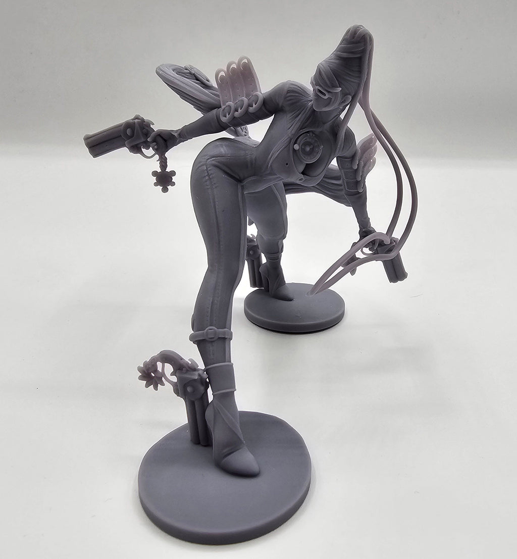 A highly detailed Bayonetta statuette showcasing her dynamic pose with dual guns and flowing hair, capturing her elegance, power, and iconic style from the video game series.