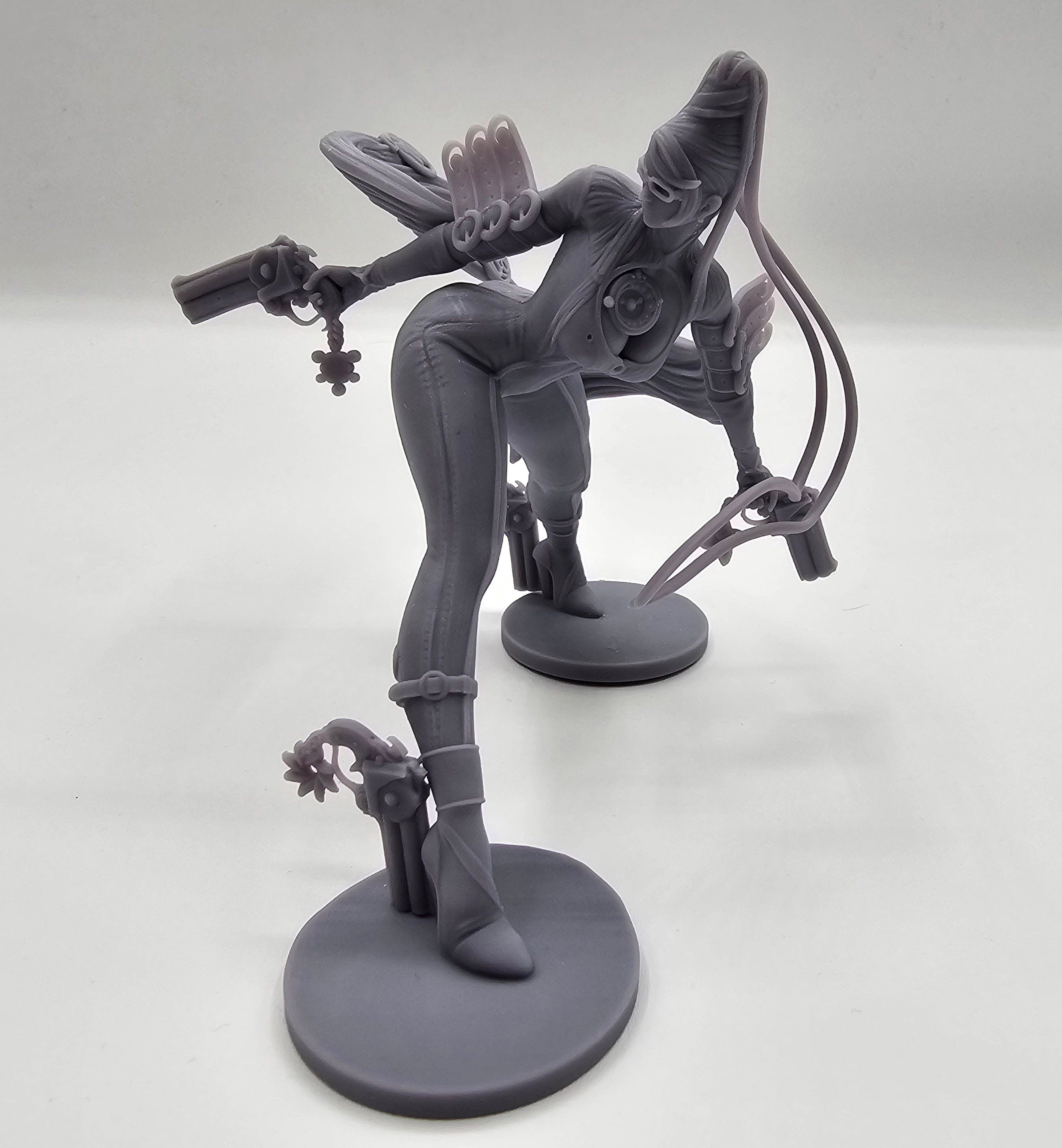 A highly detailed Bayonetta statuette showcasing her dynamic pose with dual guns and flowing hair, capturing her elegance, power, and iconic style from the video game series.