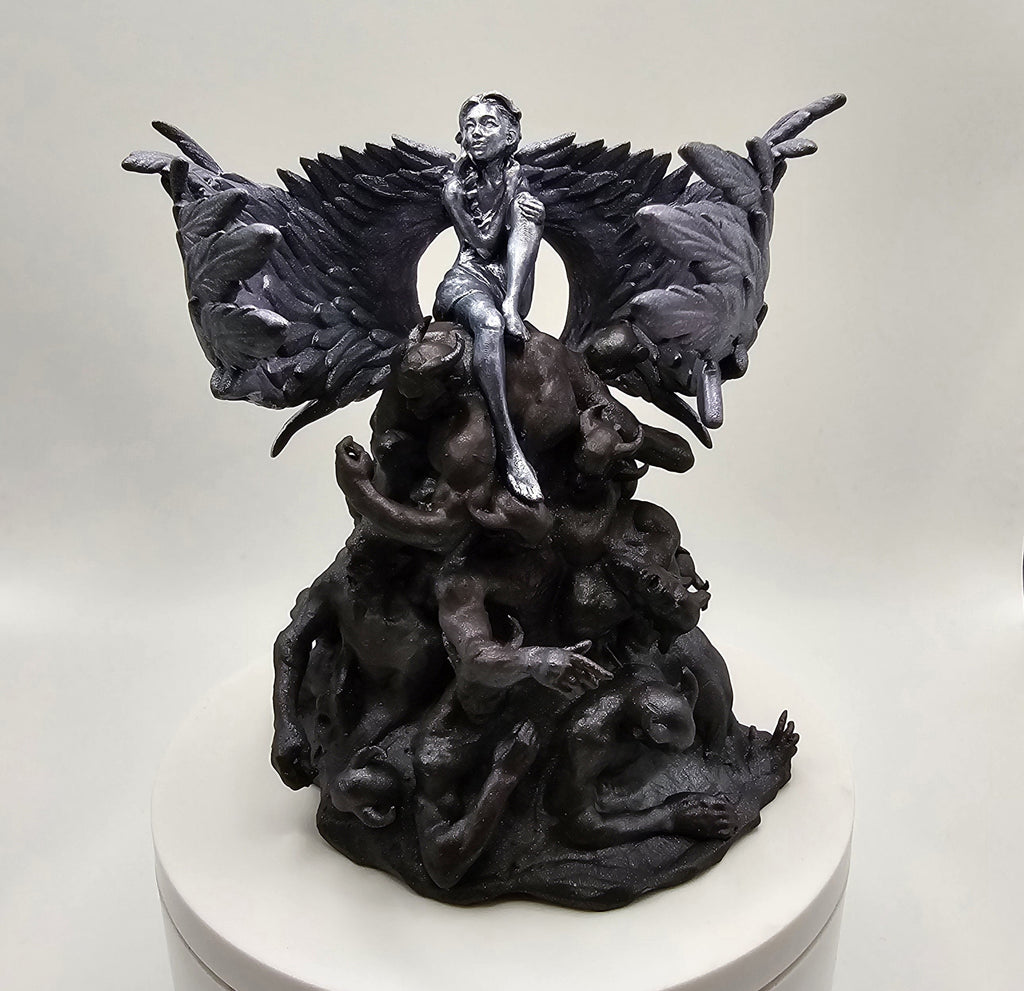 Sculpture of an angel with wide wings sitting atop a mound of intertwined figures representing darkness, depicted in intricate detail.
