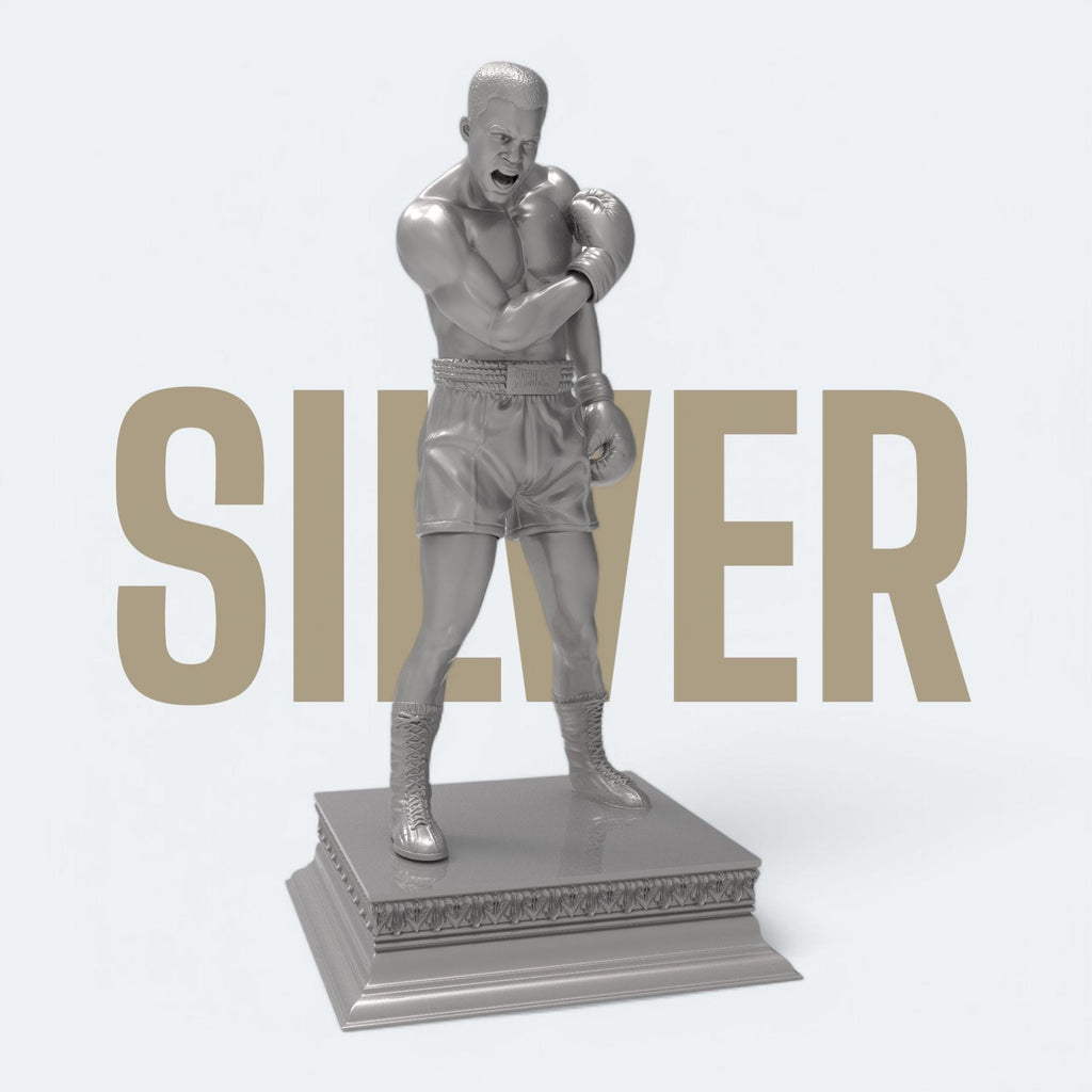 A bold tribute to the greatest of all time—this Muhammad Ali sculpture captures the raw strength and iconic energy of the boxing legend. With gloves raised and stance powerful, it’s a perfect piece for fans, collectors, and champions at heart. Available in gold and bronze finishes.
