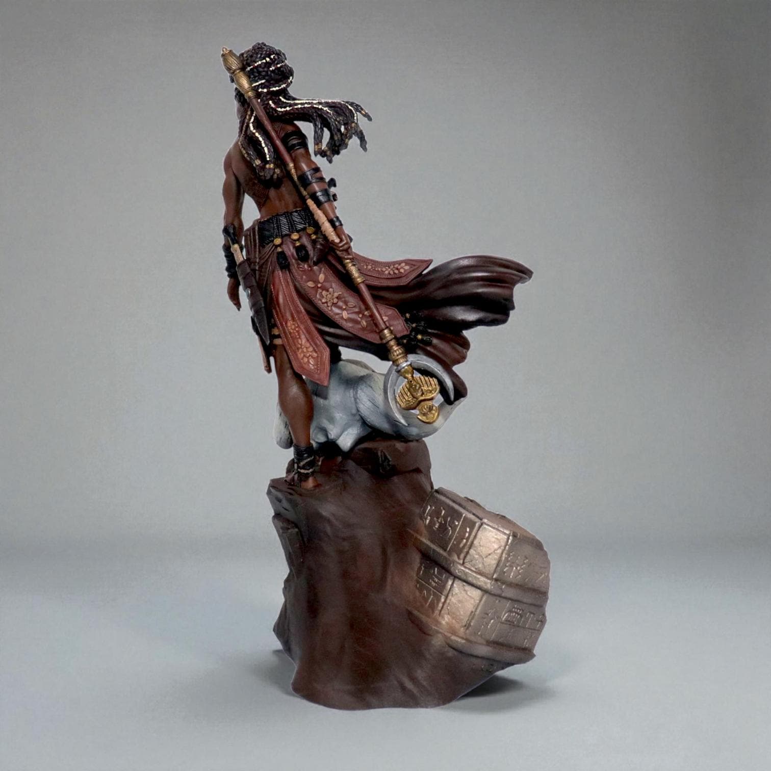 Elzebe, the Warrior Queen, stands atop a rocky skull, exuding strength and regality. Clad in intricate armor, her braided hair flows as she surveys the battlefield. A fierce leader, she embodies resilience and power, a true queen of war and legend.