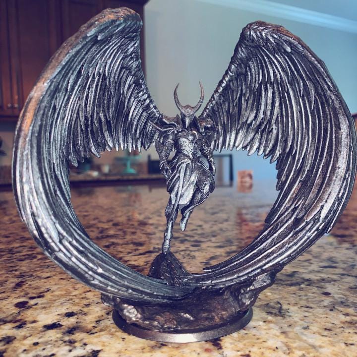 Angel Fighter, a celestial warrior with grand, curved wings, stands poised in elegant armor. With a horned helmet and flowing robes, this divine figure embodies power and grace. A stunning miniature for collectors and fantasy RPG enthusiasts.