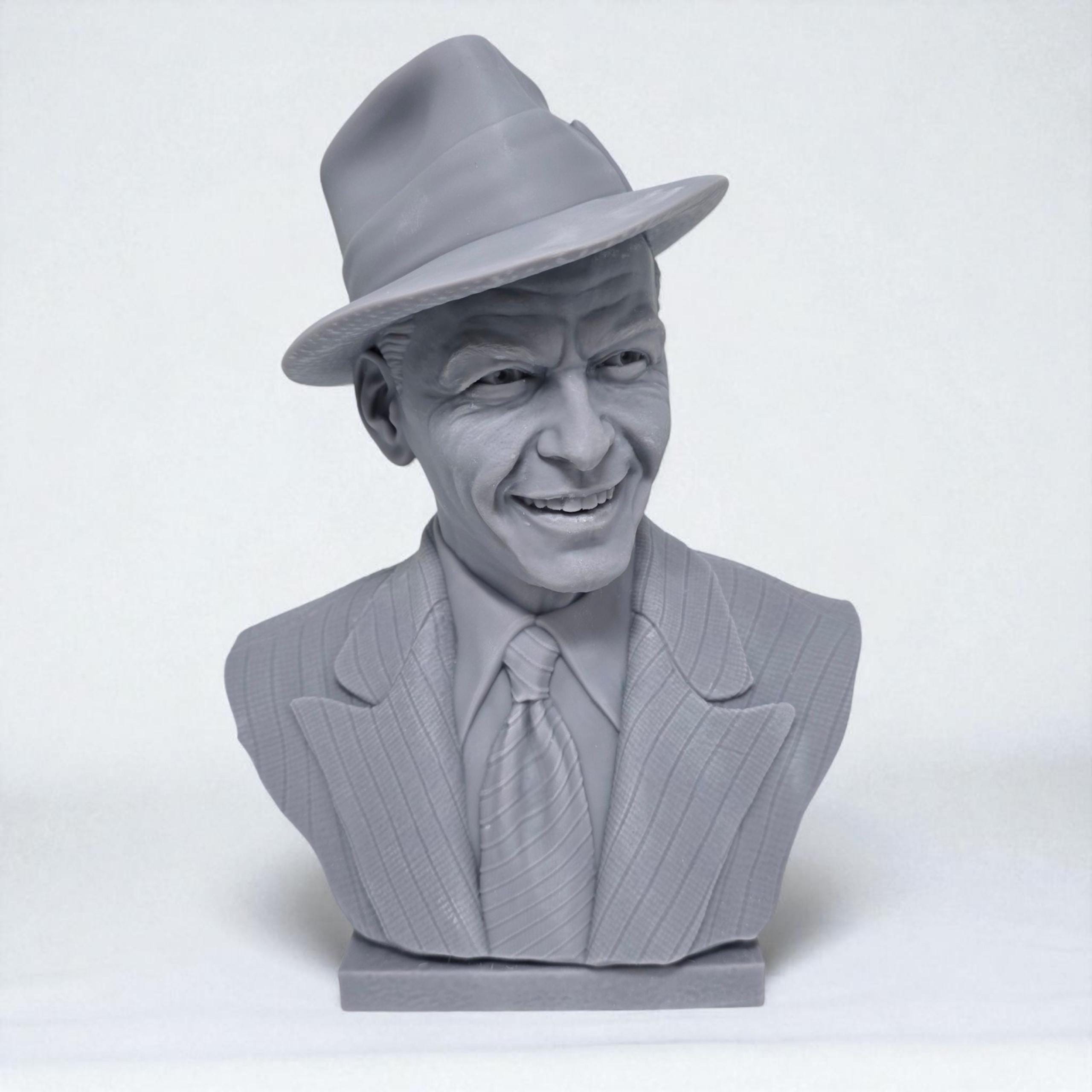 3D-printed bust of Frank Sinatra wearing a classic fedora and suit with a wide smile, showcasing detailed facial features and textured clothing. A tribute piece perfect for fans, collectors, or display décor.