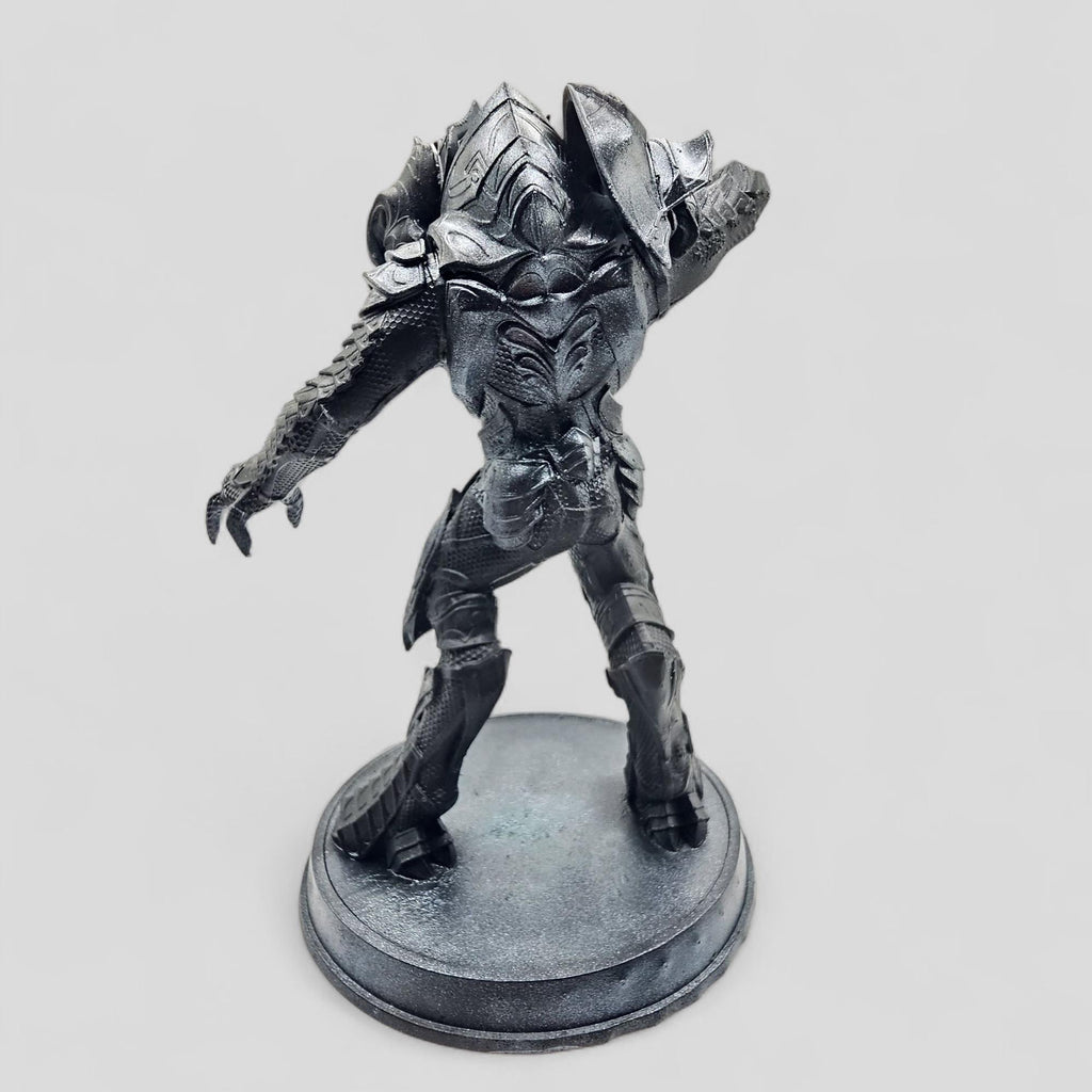 Statue of Arbiter, featuring detailed armor and a dynamic pose on a round base.