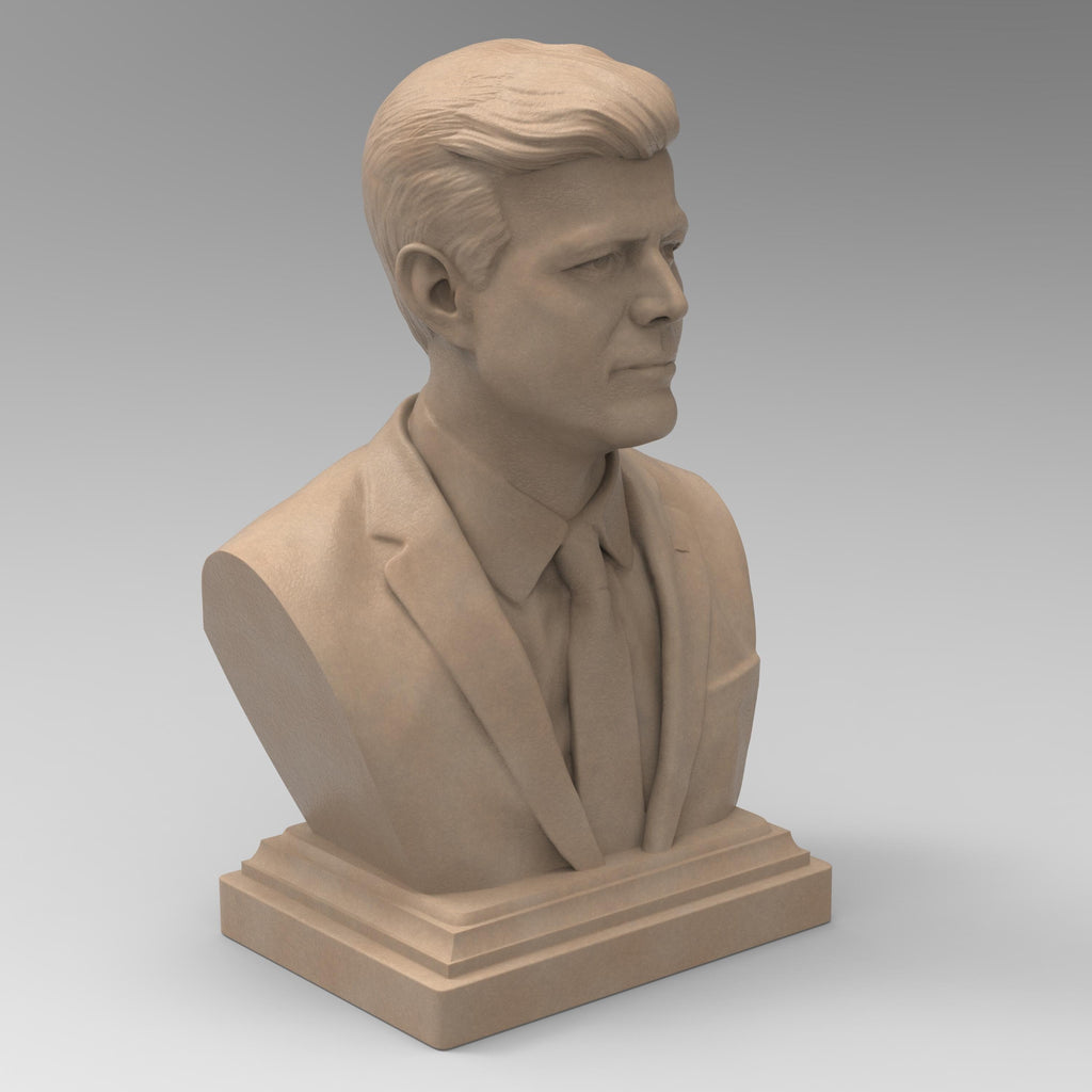Detailed bust of John F. Kennedy, depicting the 35th U.S. president in a suit and tie with a serious, contemplative expression. The sculpture captures his distinctive hairstyle and strong features, mounted on a classic pedestal base.