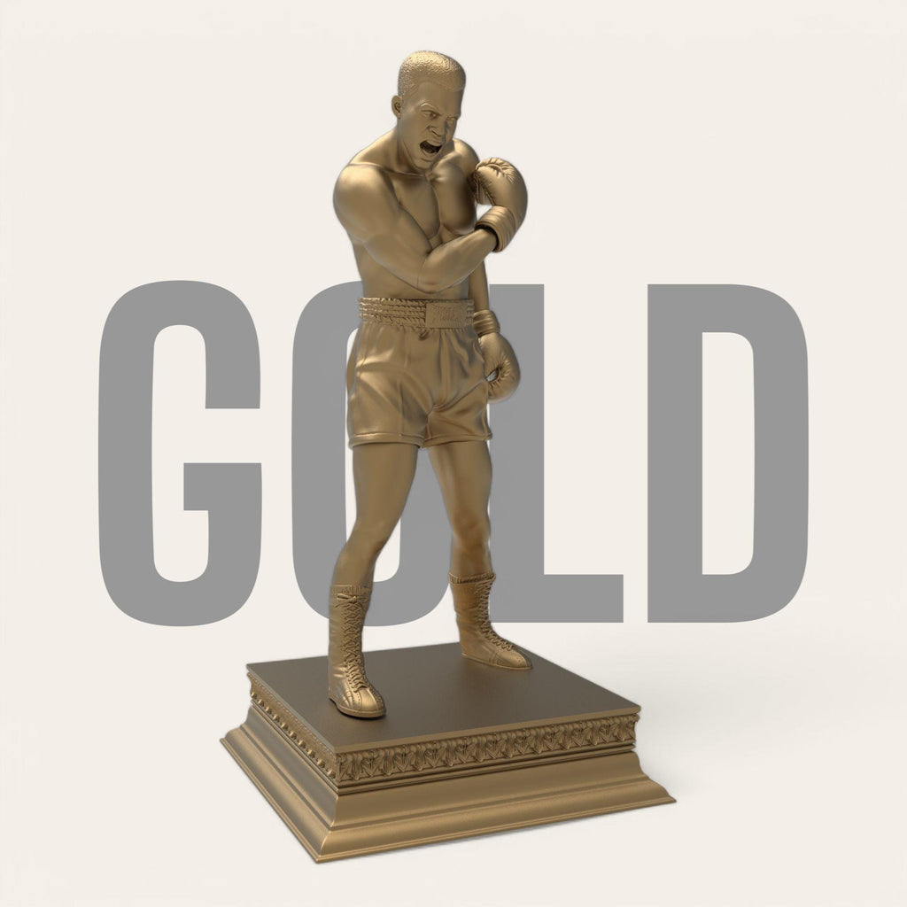 A bold tribute to the greatest of all time—this Muhammad Ali sculpture captures the raw strength and iconic energy of the boxing legend. With gloves raised and stance powerful, it’s a perfect piece for fans, collectors, and champions at heart. Available in gold and bronze finishes.