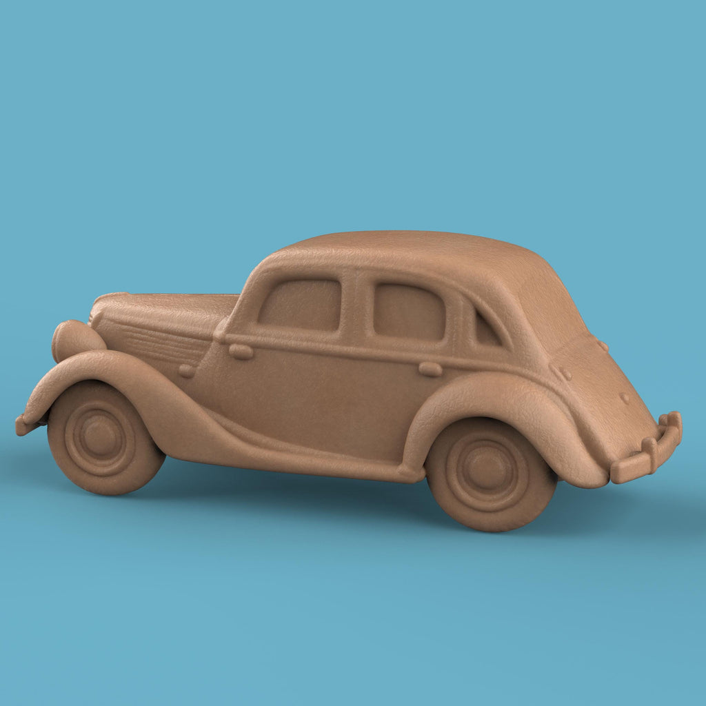 3D-printed model of a Renault 1940 BKF1 vintage car. The miniature captures smooth rounded fenders, detailed headlights, and a classic front grille design, representing the early 20th-century French automobile style.