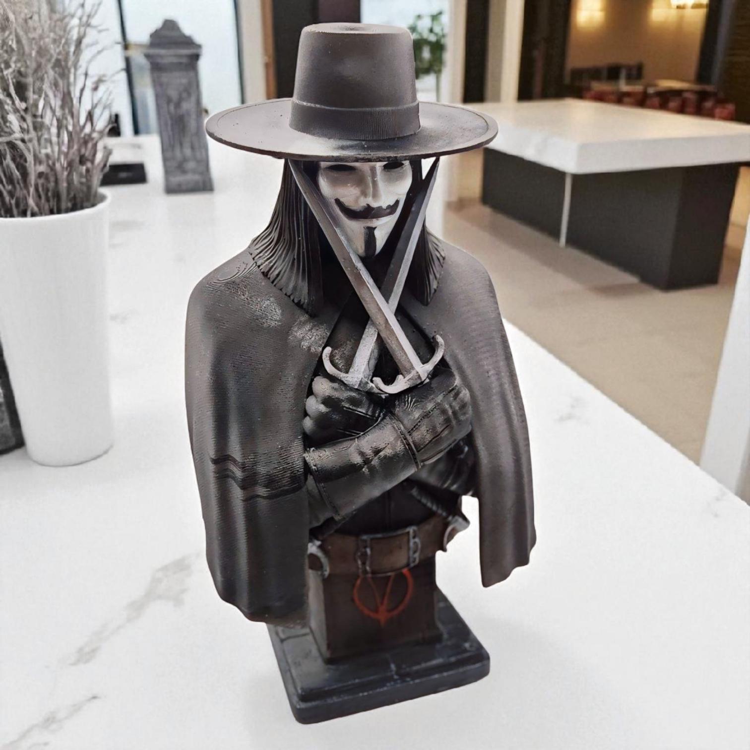 3D-printed bust of Vendetta, featuring a masked figure in a wide-brimmed hat and cloak. The character holds two crossed daggers at the chest, embodying a mysterious and rebellious presence.
