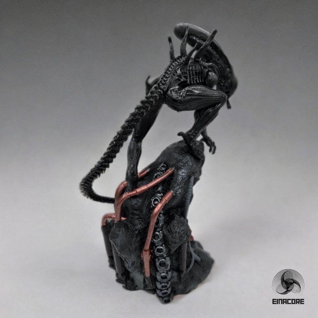 Alien Exomorph Statuette featuring intricate biomechanical details, posed on a rocky base with skulls and metallic pipes, showcasing the creature’s iconic tail and menacing posture.