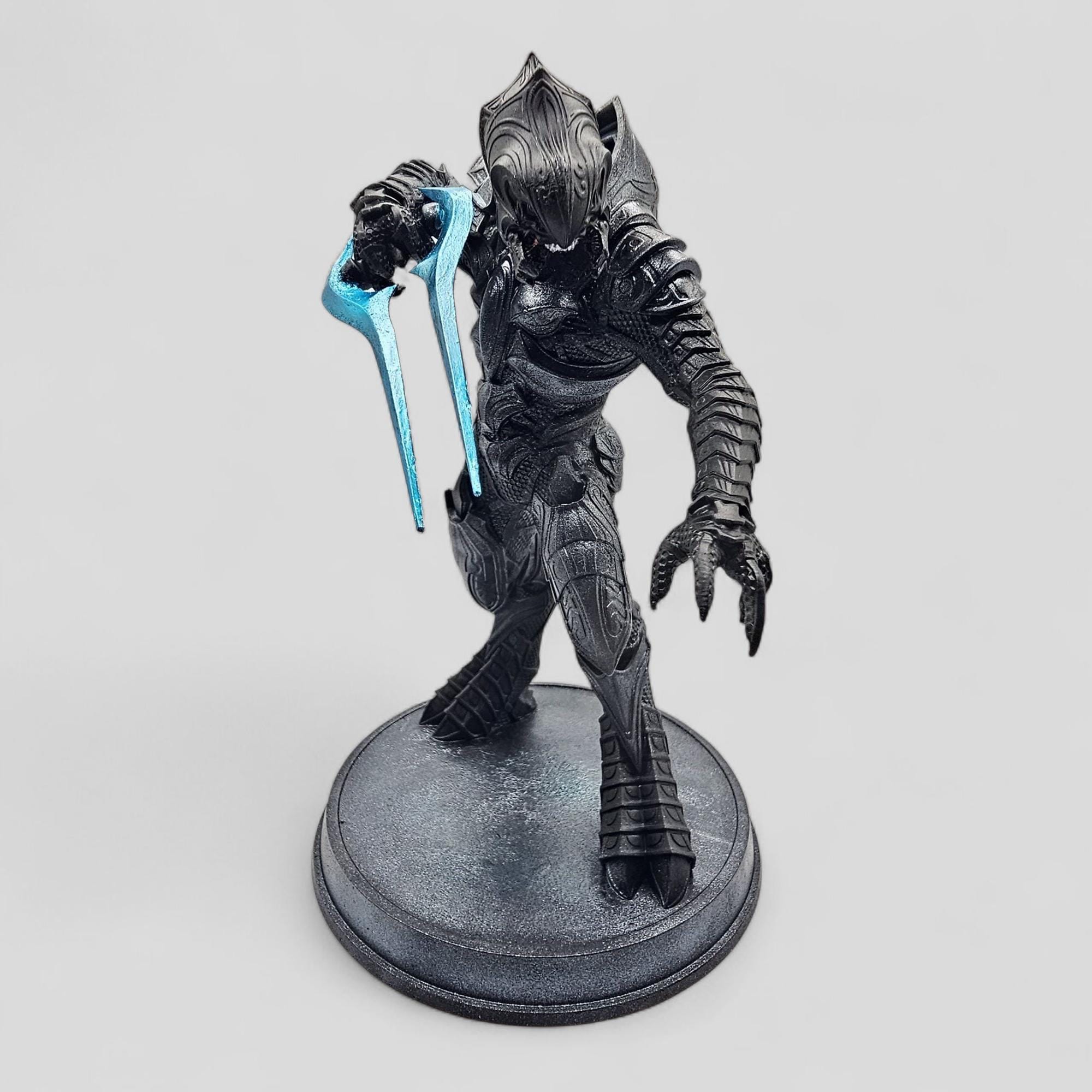 Statue of Arbiter, featuring detailed armor and a dynamic pose on a round base.