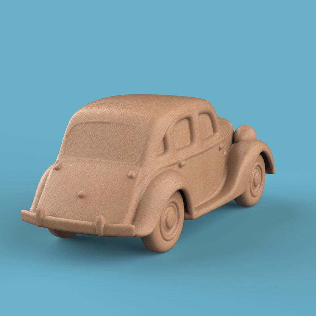 3D-printed model of a Renault 1940 BKF1 vintage car. The miniature captures smooth rounded fenders, detailed headlights, and a classic front grille design, representing the early 20th-century French automobile style.