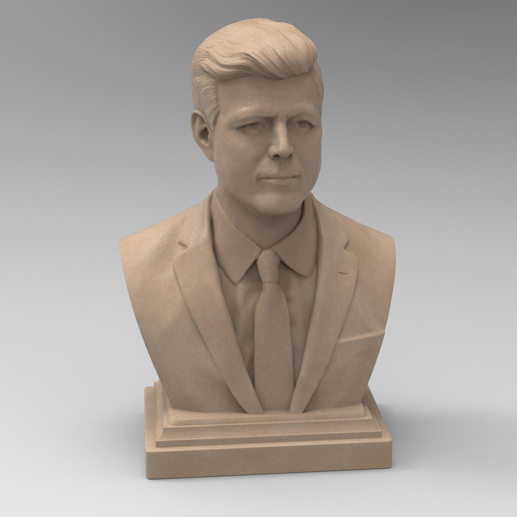 Detailed bust of John F. Kennedy, depicting the 35th U.S. president in a suit and tie with a serious, contemplative expression. The sculpture captures his distinctive hairstyle and strong features, mounted on a classic pedestal base.