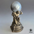 A detailed figurine of Atlas carrying the globe on his shoulders, showcasing a classic mythological design with intricate bronze and silver tones, displayed on a pedestal base.