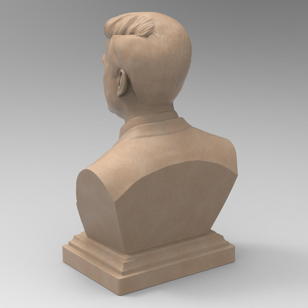 Detailed bust of John F. Kennedy, depicting the 35th U.S. president in a suit and tie with a serious, contemplative expression. The sculpture captures his distinctive hairstyle and strong features, mounted on a classic pedestal base.