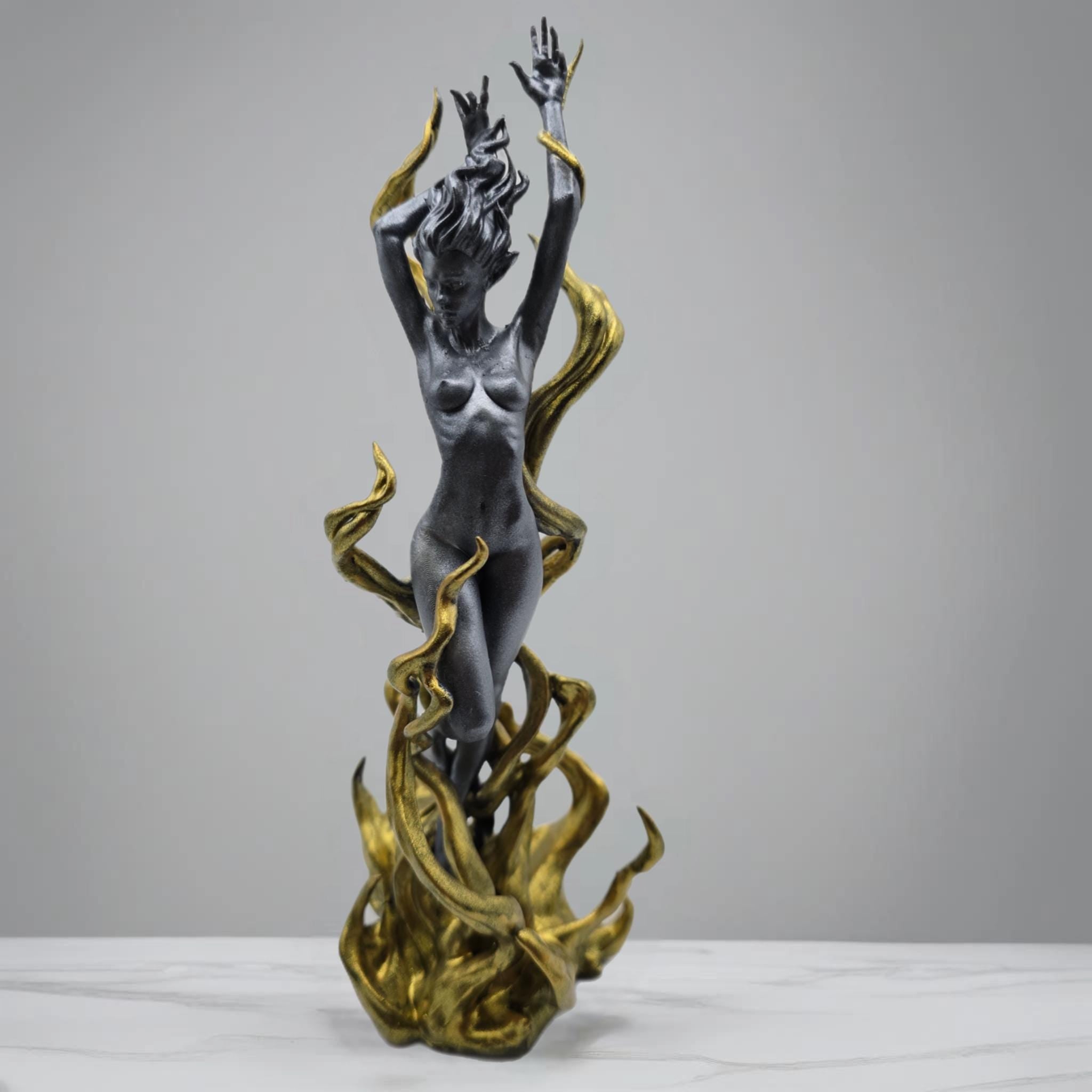 Stunning Flame Goddess statuette in silver and gold, featuring intricate details of flames and vines embracing a dynamic, graceful figure. A captivating centerpiece or collectible art piece, perfect for adding elegance and energy to any home decor
