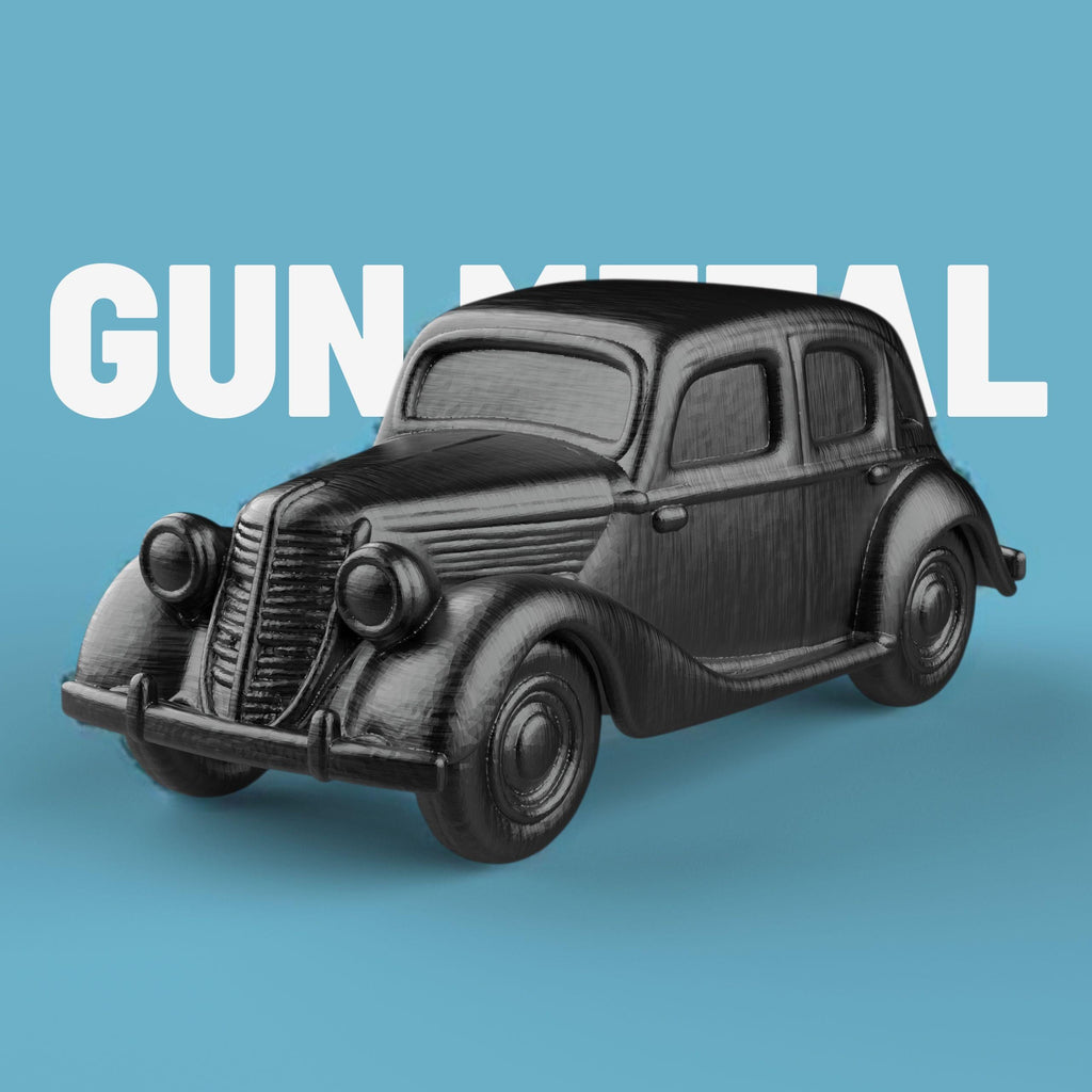 3D-printed model of a Renault 1940 BKF1 vintage car. The miniature captures smooth rounded fenders, detailed headlights, and a classic front grille design, representing the early 20th-century French automobile style.