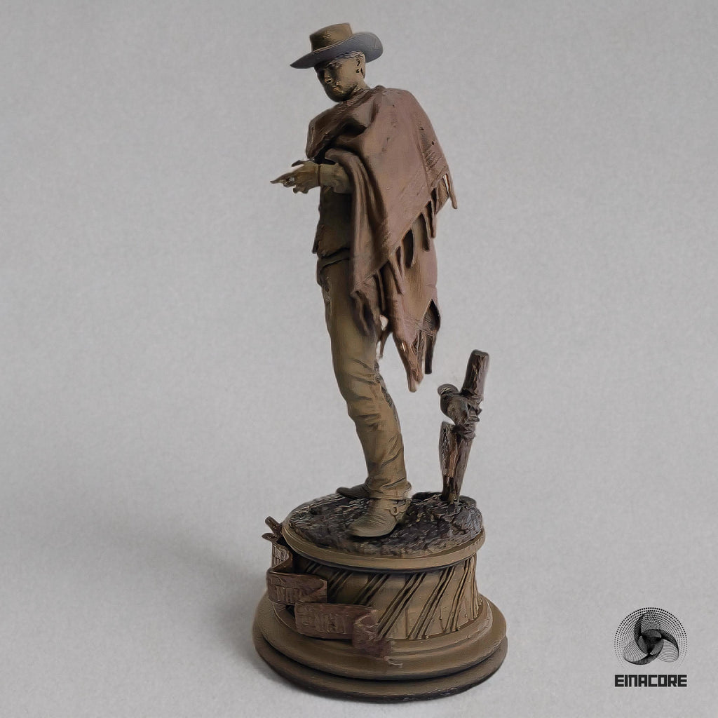 Statue of Clint Eastwood in a cowboy outfit, featuring a poncho, hat, and revolver, standing on a detailed round base with decorative elements.