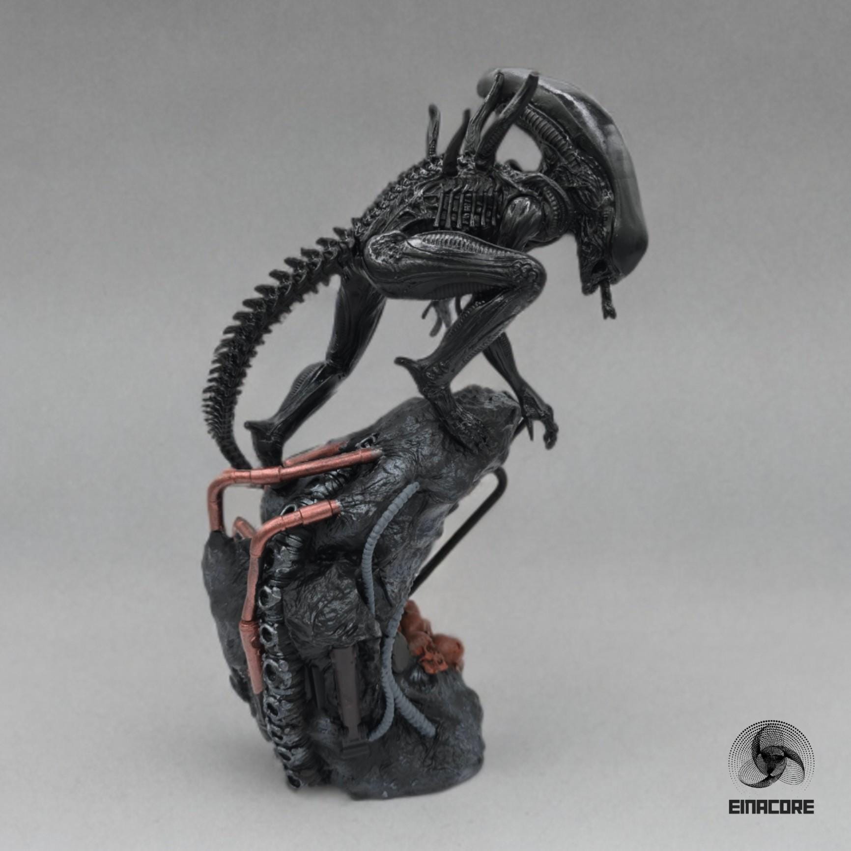 Alien Exomorph Statuette featuring intricate biomechanical details, posed on a rocky base with skulls and metallic pipes, showcasing the creature’s iconic tail and menacing posture.