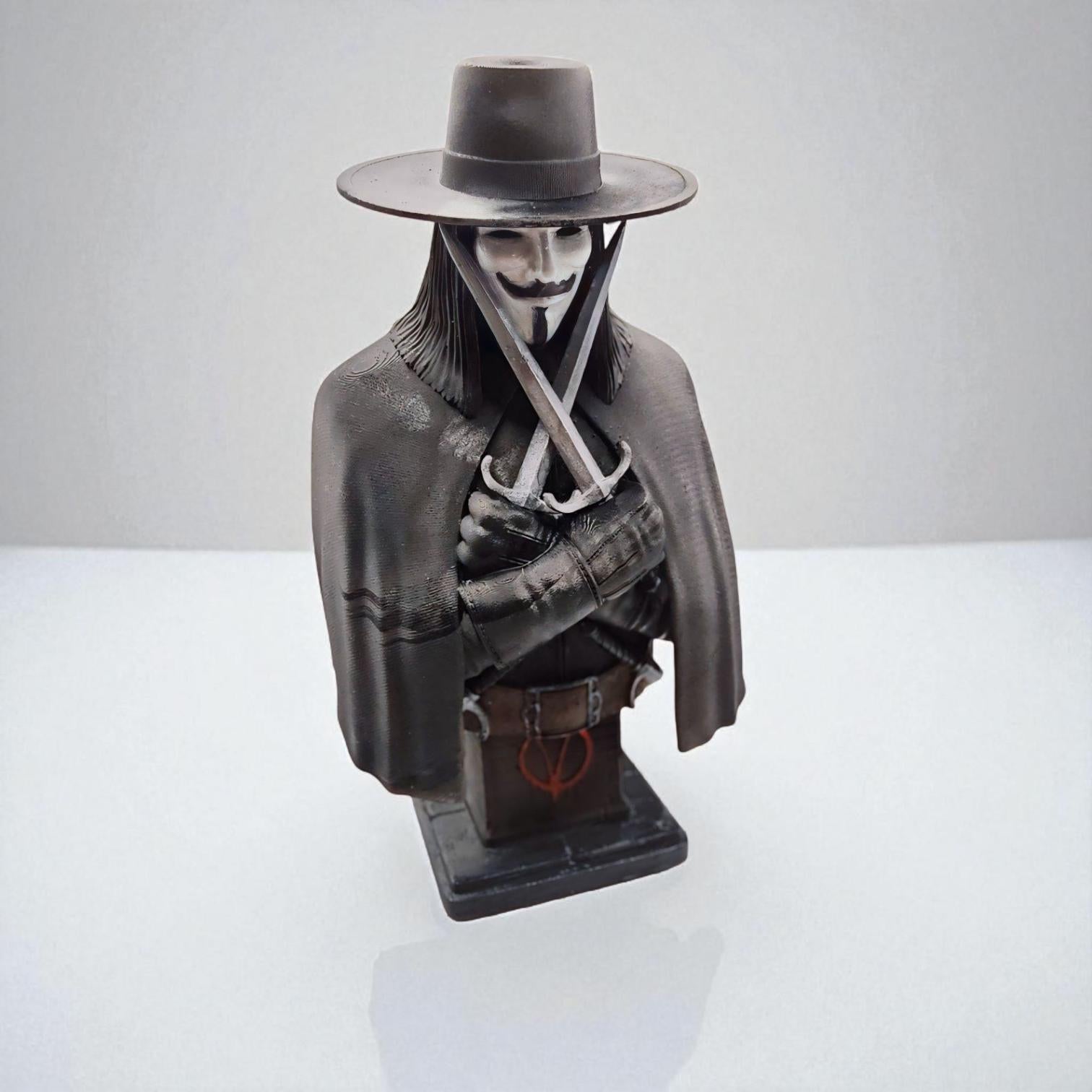 3D-printed bust of Vendetta, featuring a masked figure in a wide-brimmed hat and cloak. The character holds two crossed daggers at the chest, embodying a mysterious and rebellious presence.