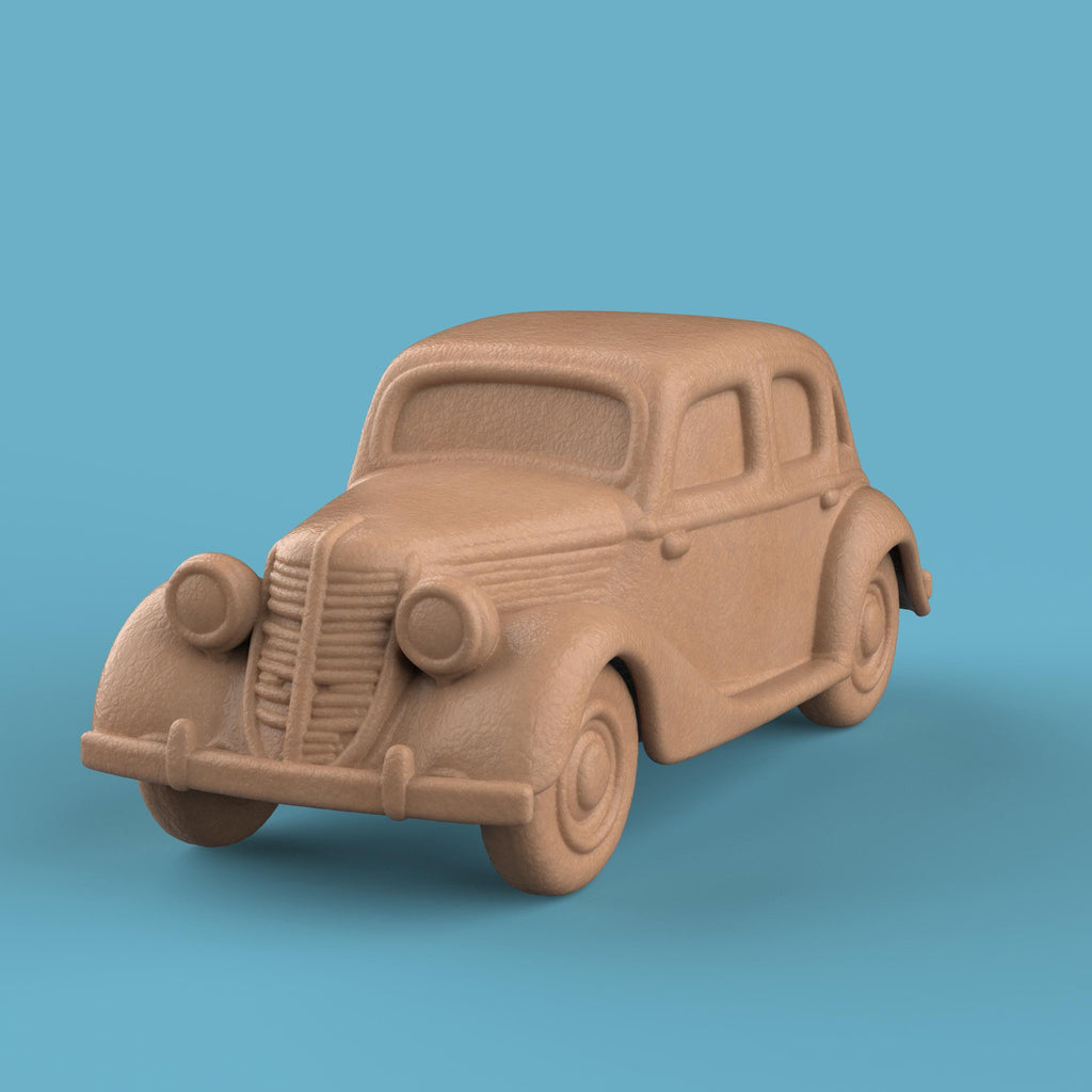 3D-printed model of a Renault 1940 BKF1 vintage car. The miniature captures smooth rounded fenders, detailed headlights, and a classic front grille design, representing the early 20th-century French automobile style.