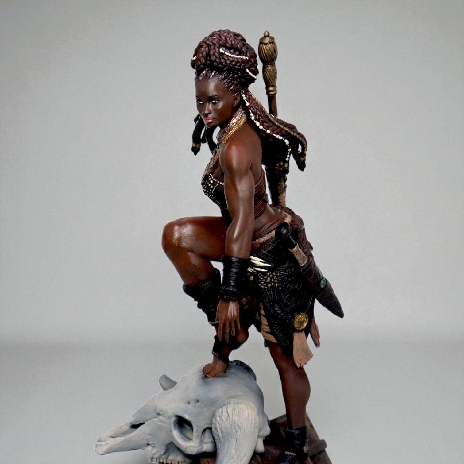 Elzebe, the Warrior Queen, stands atop a rocky skull, exuding strength and regality. Clad in intricate armor, her braided hair flows as she surveys the battlefield. A fierce leader, she embodies resilience and power, a true queen of war and legend.