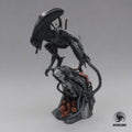 Alien Exomorph Statuette featuring intricate biomechanical details, posed on a rocky base with skulls and metallic pipes, showcasing the creature’s iconic tail and menacing posture.