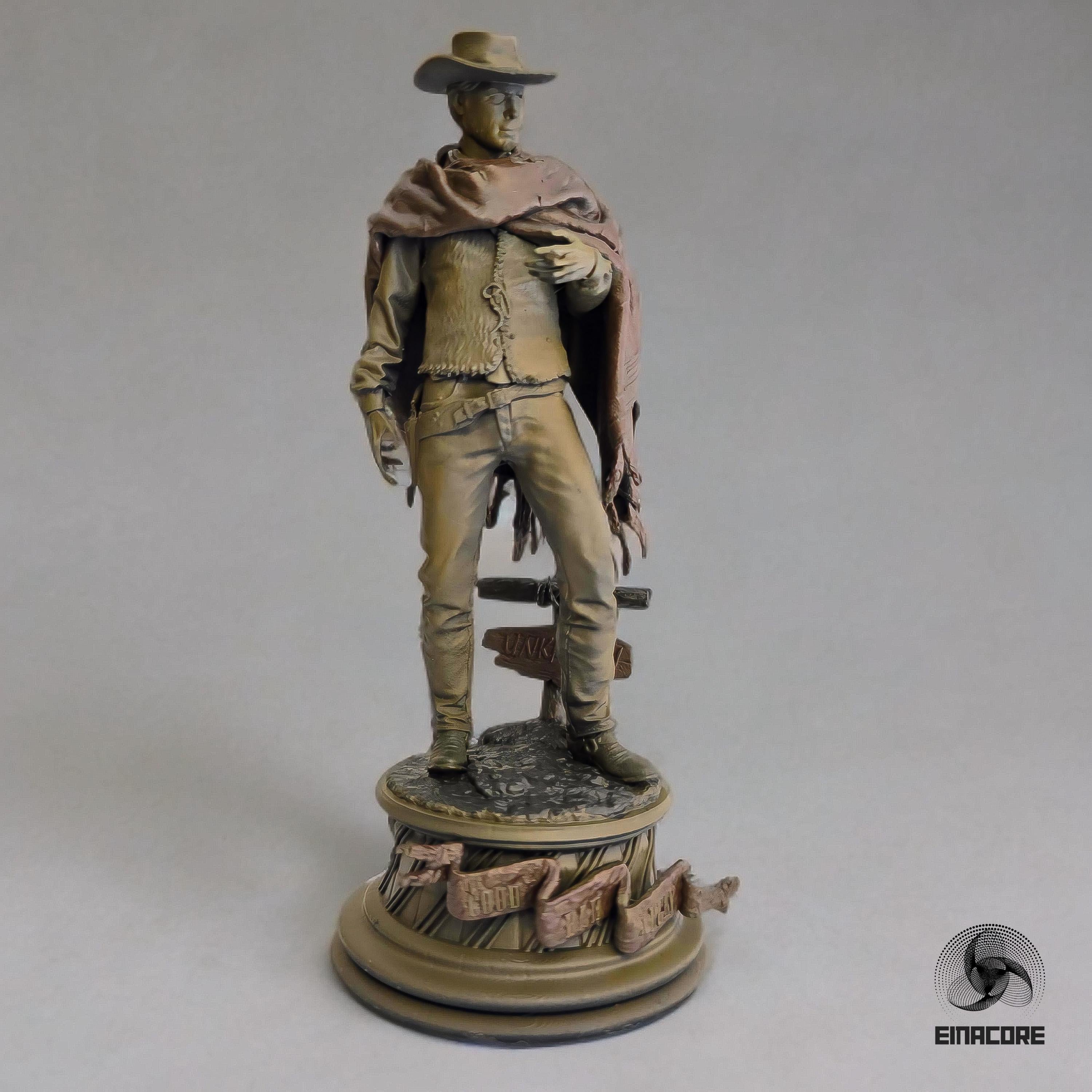 Statue of Clint Eastwood in a cowboy outfit, featuring a poncho, hat, and revolver, standing on a detailed round base with decorative elements.