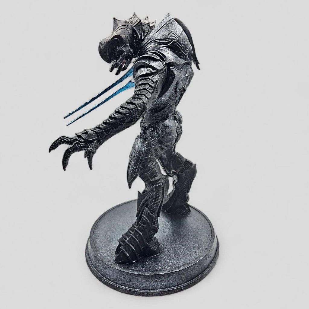 Statue of Arbiter, featuring detailed armor and a dynamic pose on a round base.
