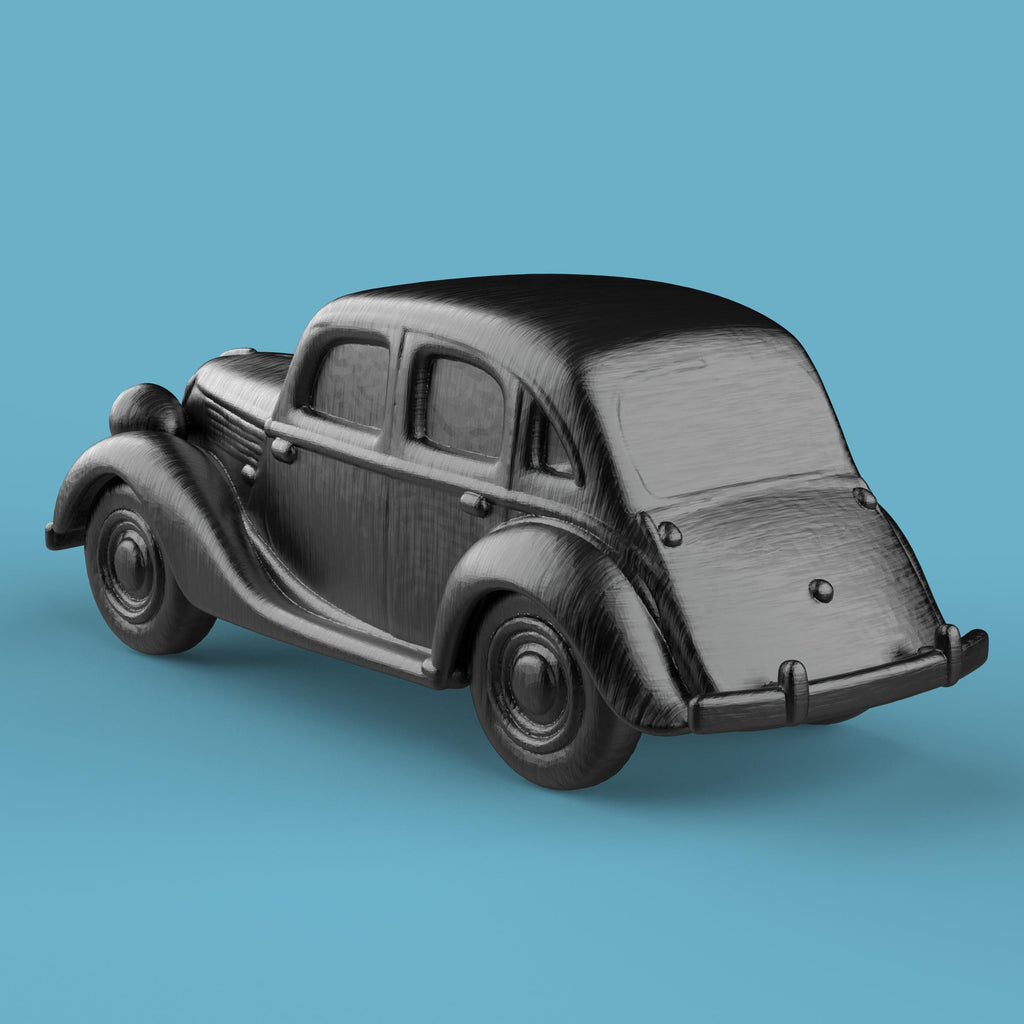 3D-printed model of a Renault 1940 BKF1 vintage car. The miniature captures smooth rounded fenders, detailed headlights, and a classic front grille design, representing the early 20th-century French automobile style.