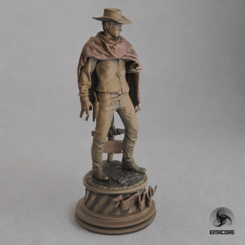 Statue of Clint Eastwood in a cowboy outfit, featuring a poncho, hat, and revolver, standing on a detailed round base with decorative elements.