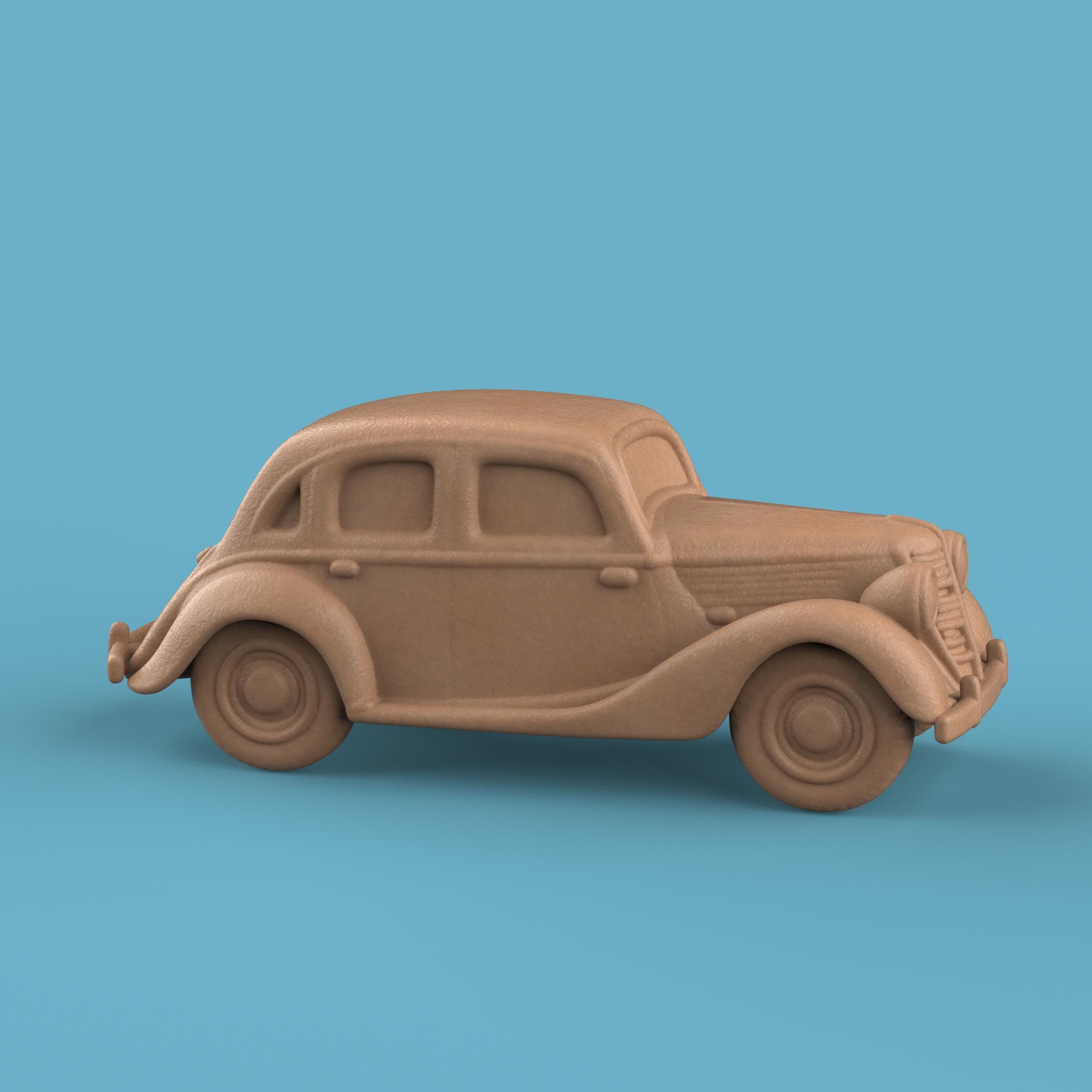 3D-printed model of a Renault 1940 BKF1 vintage car. The miniature captures smooth rounded fenders, detailed headlights, and a classic front grille design, representing the early 20th-century French automobile style.