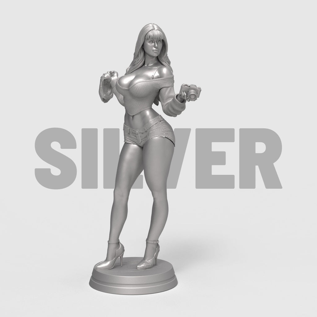 Stylized 3D-printed figurine of Mary Jane in a confident pose, holding a camera in one hand and a cloth in the other. She is dressed in a cropped sweater and short shorts, with long flowing hair and high heels. Available in bronze, gold, and silver finishes, the sculpture showcases fine detail and a modern, fashionable aesthetic.
